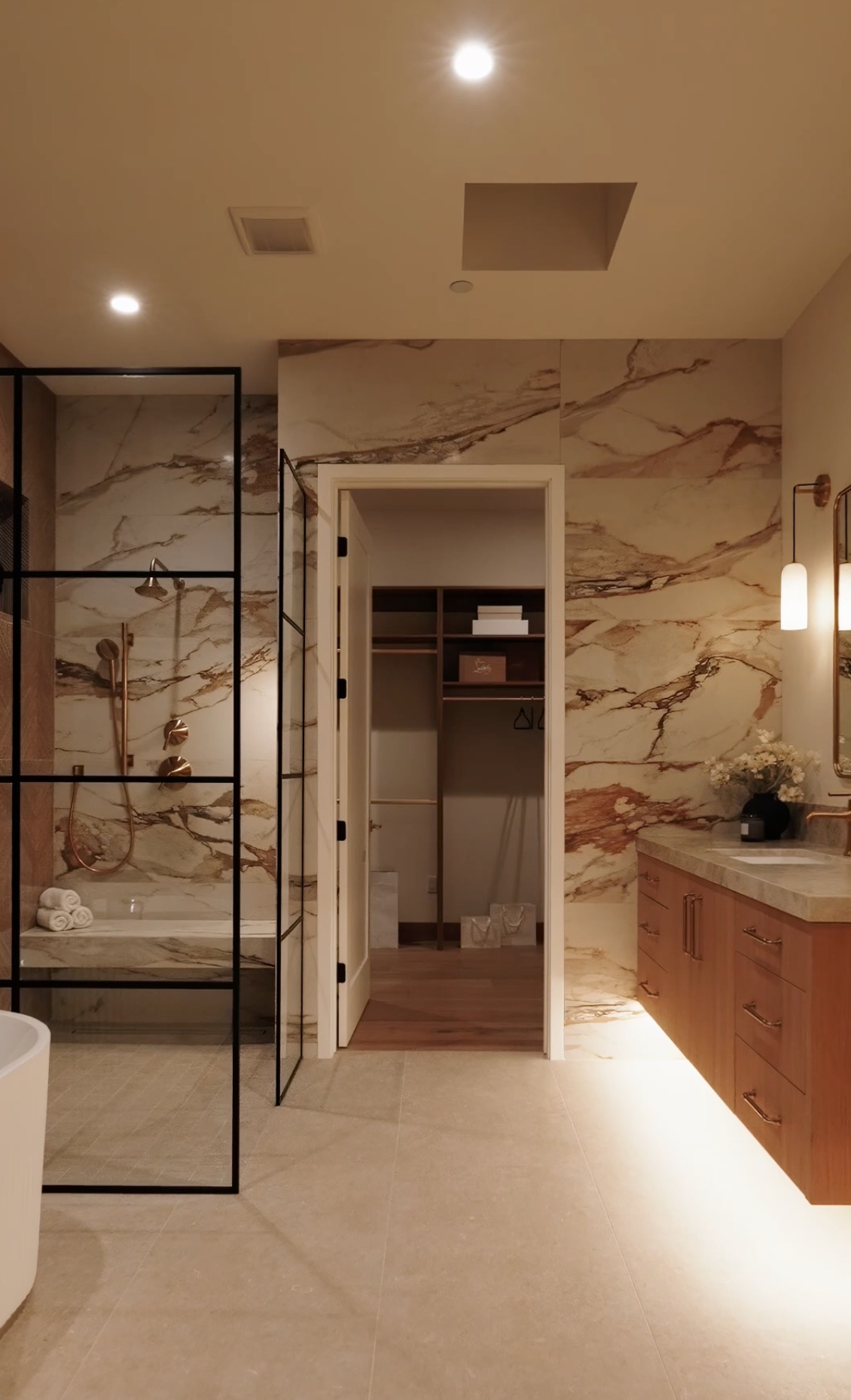 Westminster residence bathroom with dramatic marble shower walls, black steel enclosure, oak vanity, and brass fixtures